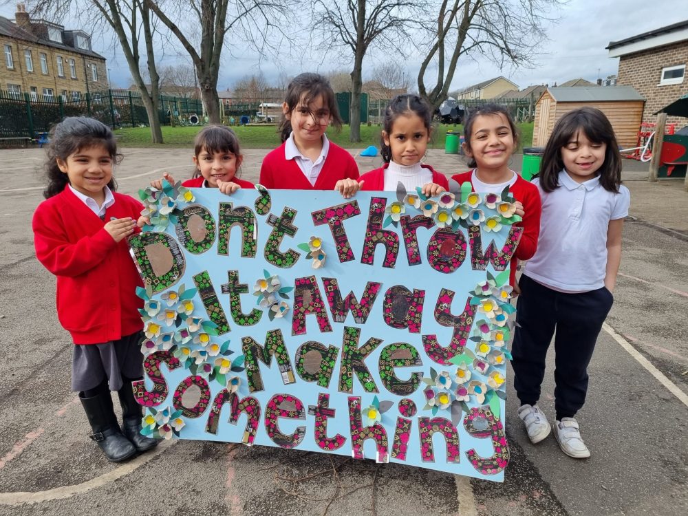 group of children sharing recycled art work